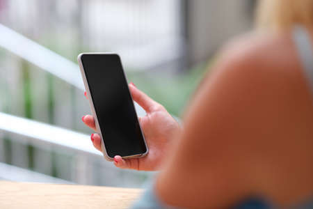Woman holding a smartphone, hands close-up