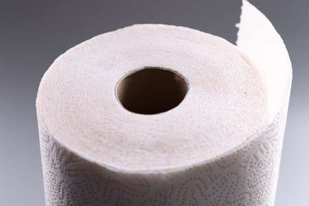 Roll of toilet paper on gray background.の写真素材