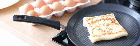 Pancake with delicious filling frieding in pan in kitchen closeupの写真素材