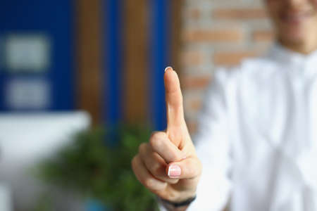 Young woman person show index finger or press virtual screen knobの写真素材