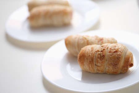 Delicious pigs in a blanket on a white plateの写真素材