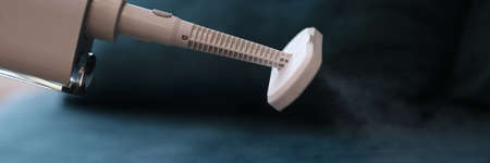 Cleaning of furniture with white vacuum cleaner with steam for disinfectionの写真素材