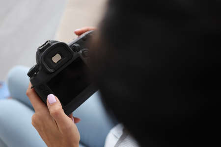 Woman hold turned off camera, black screen, not work after damageの写真素材