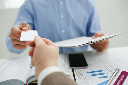 Businesspeople executive exchange business cards in office after end of meetingの写真素材