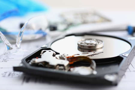 Disassembled hard drive from pc hdd and reader arm, made of plastic and metal