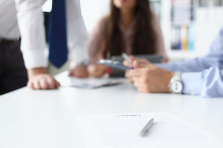 Businesspeople having meeting in conference room, contract paper with pen on deskの写真素材