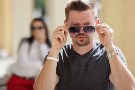 Middle aged stylish male wearing sunglasses, handsome person posing for pictureの写真素材
