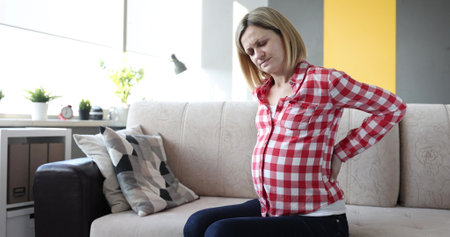 Beautiful pregnant woman having body aches closeup