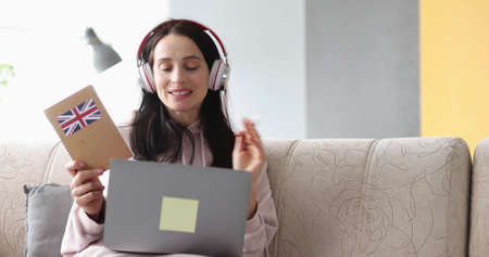 Smiling woman being assessed english remotely at home closeup