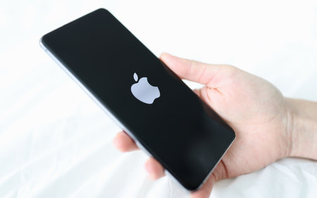 Hand holding new iPhone 13 pro closeupのeditorial素材