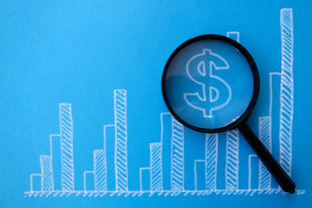 Business graph with dollar icon and lens blue backgroundの写真素材