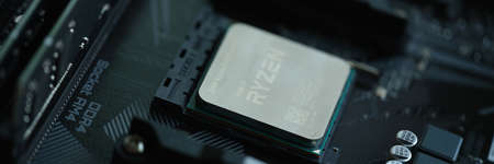 AMD Ryzen processor installed in motherboard slot AM4 closeup