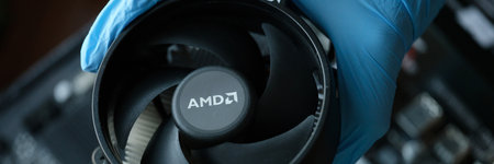 Hand in glove installs cpu fan AMD closeupのeditorial素材
