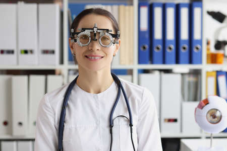 Woman wear optometrist trial frame at ophthalmology clinic, ophthalmologist help select glassesの写真素材