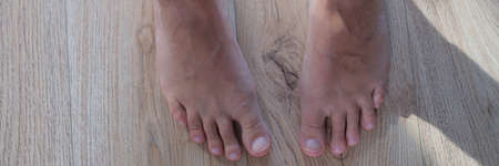 Feet of female legs, close-up. Standing barefoot on the floor