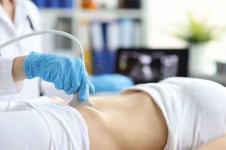 Ultrasound of woman in early pregnancy in clinicの写真素材