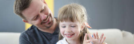 Dad and girl clapping hands