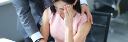 Businessman pestering female colleague in the workplace.