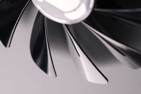 Cooling fan with plastic black blades on grey backgroundの写真素材