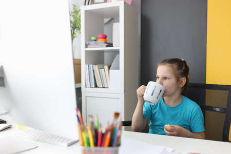 Little girl using laptop watch funny cartoons at home.