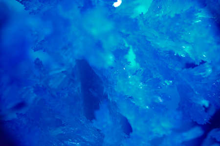 Frosty drawing in blue colour on window