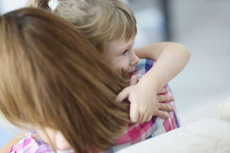 Mother and daughter hugging, mother comfort little kid, warm precious family momentの写真素材
