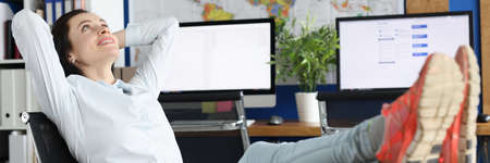 Beautiful woman in the office dreaming and looking at the ceiling