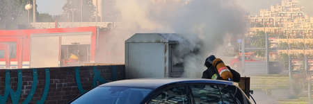 A firefighter runs down the street to the source of the fire