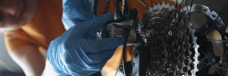 Woman repairing bicycle chain at home, close-upの写真素材