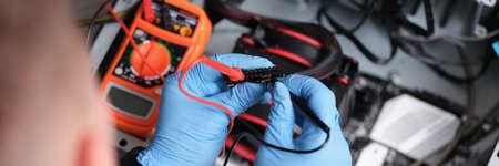Man working with multimeter for computer repair