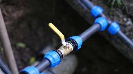 Water valve connected to PVC pipe closeupの写真素材