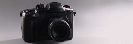Closeup of black professional camera on gray backgroundの写真素材