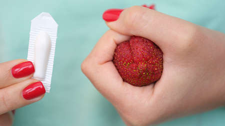 Woman hand holds medical candles for constipation and anatomy of anus