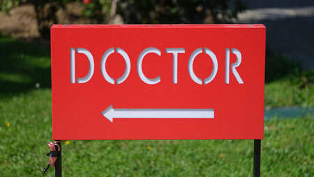 Red table with word doctor and arrowの写真素材