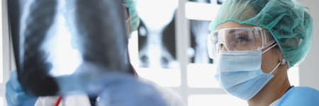Nurse woman ask advice qualified doctor about patients x ray