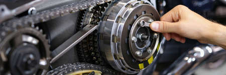 Professional mechanic fix part of motorbike vehicle with wrench tool