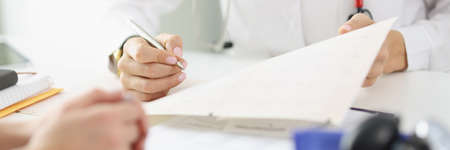 Doctor fill report in office or prescribe medication for ill patientの写真素材