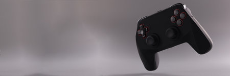 Black game joystick with buttons on gray background