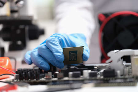 Installing modern central processor unit into motherboardの写真素材