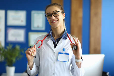 Portrait of smiling young female doctor in glasses