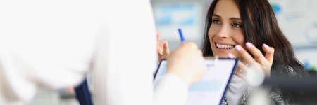 Business people discussing documents with graphs in officeの写真素材