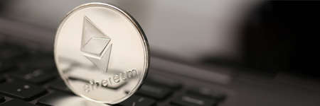 Ethereum silver coin on laptop pc keyboard