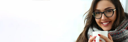 Beautiful girl is holding large cup in hands closeupの写真素材