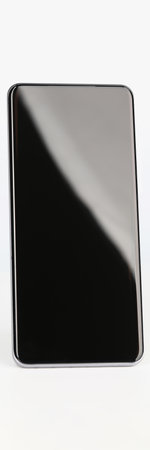 Black smartphone stands upright on a white background
