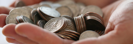 Pile of coins in businessman hands, earned money, work hard