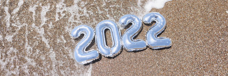 2022 figures in the water on the golden sea sand