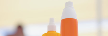 Orange and yellow bottles with a dispenser, blurryの写真素材