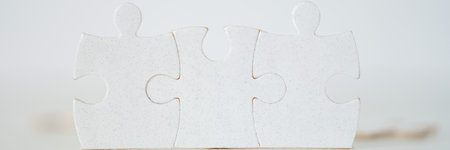 White pieces of puzzle put together, connected parts, lined detailsの写真素材