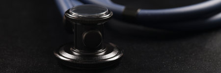 Medical stethoscope instrument on black surface, tool for patient diagnosticの写真素材