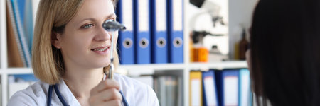 Neurologist holds hammer in front of patient eyes in clinicの写真素材
